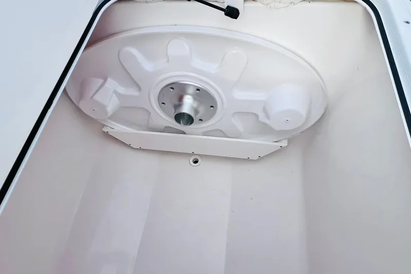 Slide: The Image of 2019 Bryant POTENZA 270 boat storage compartment with white interior and circular lid. - 74