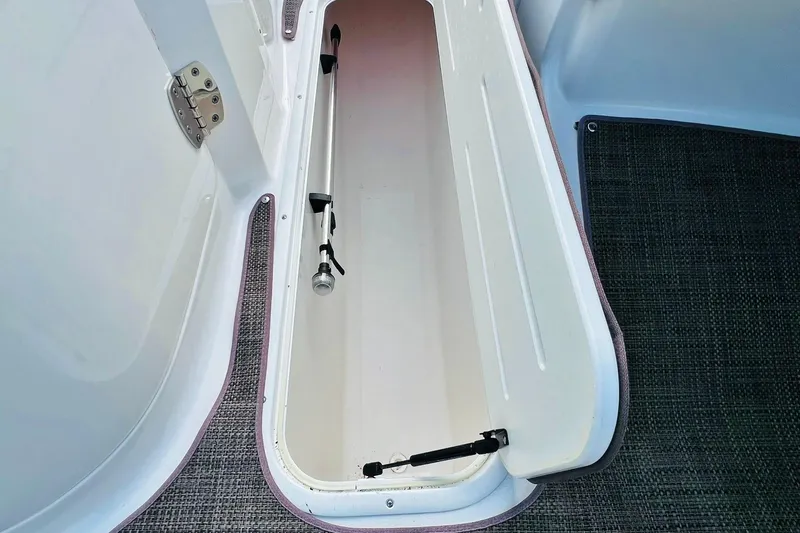 Slide: The Image of Open storage compartment in 2019 Bryant POTENZA 270 boat, featuring a clean interior. - 75