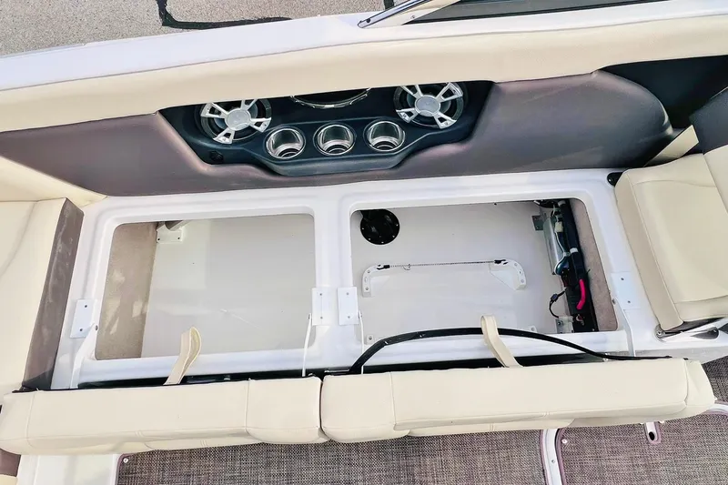 Slide: The Image of 2019 Bryant POTENZA 270 boat interior with open storage compartments and cup holders. - 76