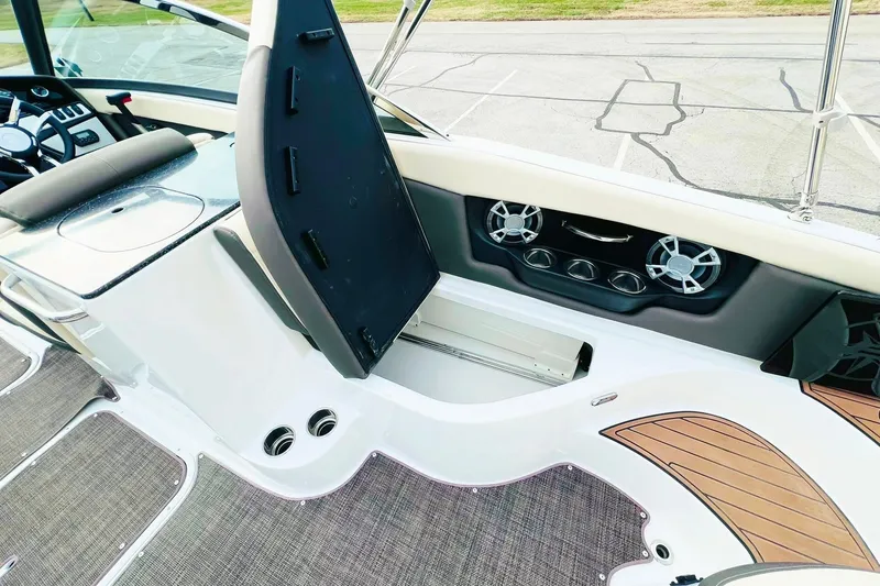 Slide: The Image of 2019 Bryant POTENZA 270 boat interior with open storage compartment and speaker system. - 78