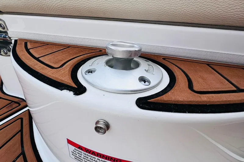 Slide: The Image of 2019 Bryant POTENZA 270 boat cleat on teak deck with warning label. - 80