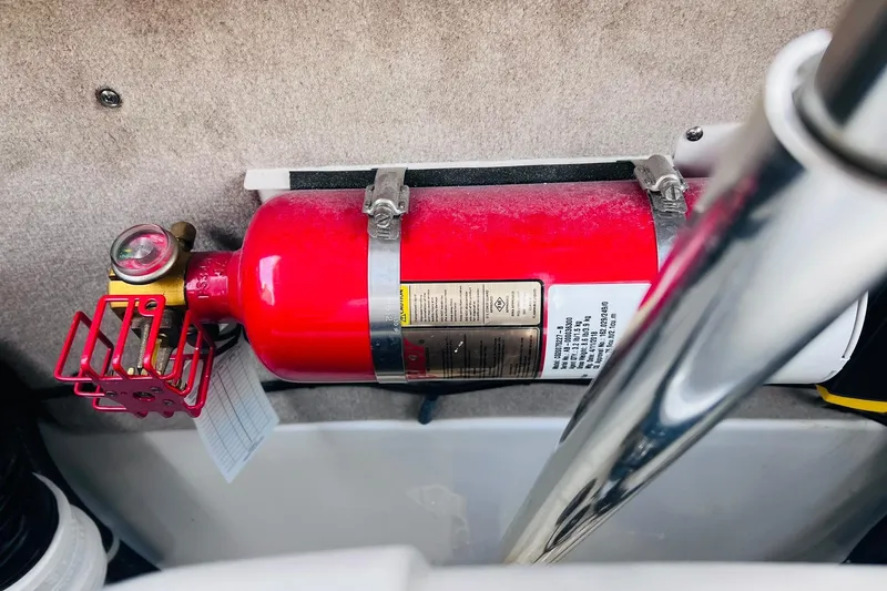 Slide: The Image of Red fire extinguisher mounted on a 2019 Bryant POTENZA 270 boat interior. - 89