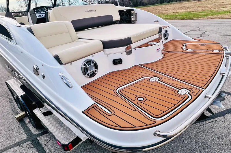 Slide: The Image of 2019 Bryant Potenza boat with teak deck and beige seating on a trailer. - 9