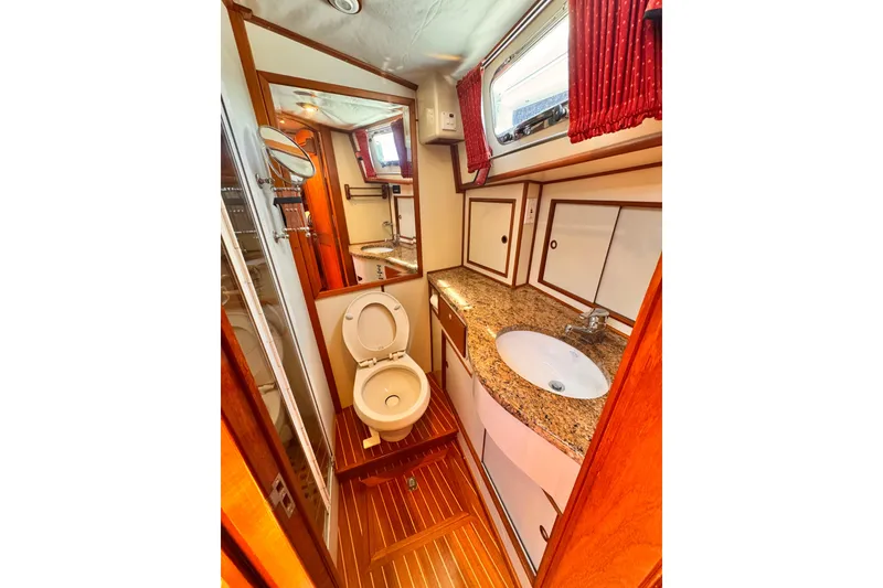 Slide: The Image of Cockpit of 2000 Grand Banks East Bay 49 with navigation equipment and marina view. - 14