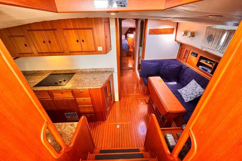 Slide: The Image of Grand Banks East Bay 49 yacht deck with chairs and inflatable boat in marina. - 7