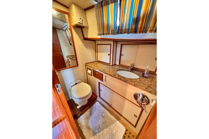 Slide: The Image of Luxurious 2000 Grand Banks East Bay 49 yacht interior with elegant seating and marina view. - 8
