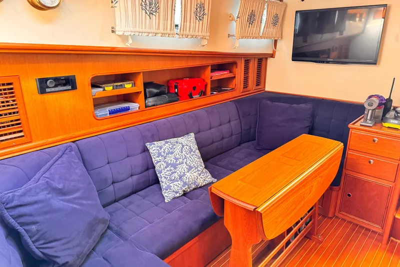 Slide: The Image of Luxurious interior of 2000 Grand Banks East Bay 49 yacht with plush seating and wooden accents. - 10