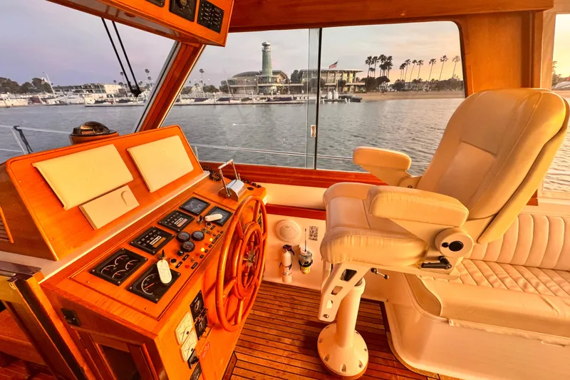 Slide: The Image of Helm of 2000 Grand Banks East Bay 49 yacht with harbor view. - 20