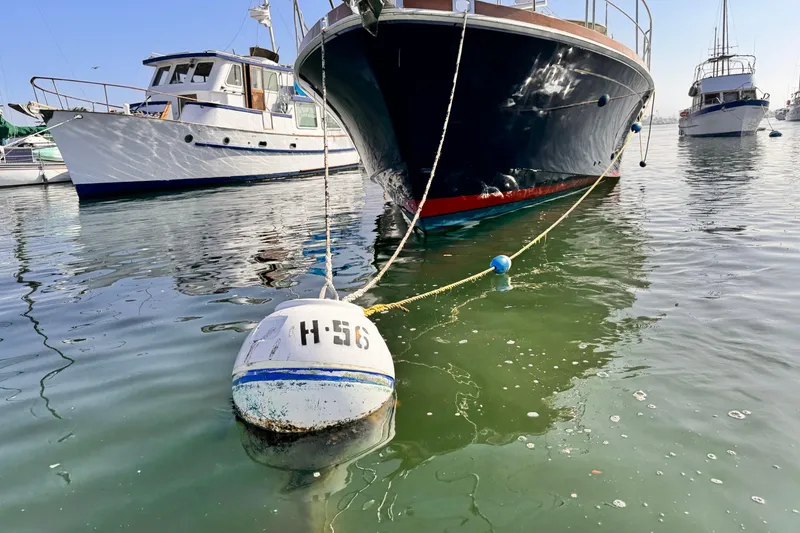 Slide: The Image of Grand Banks East Bay 49 yacht moored with buoy H-56 in a marina, 2000 model. - 3