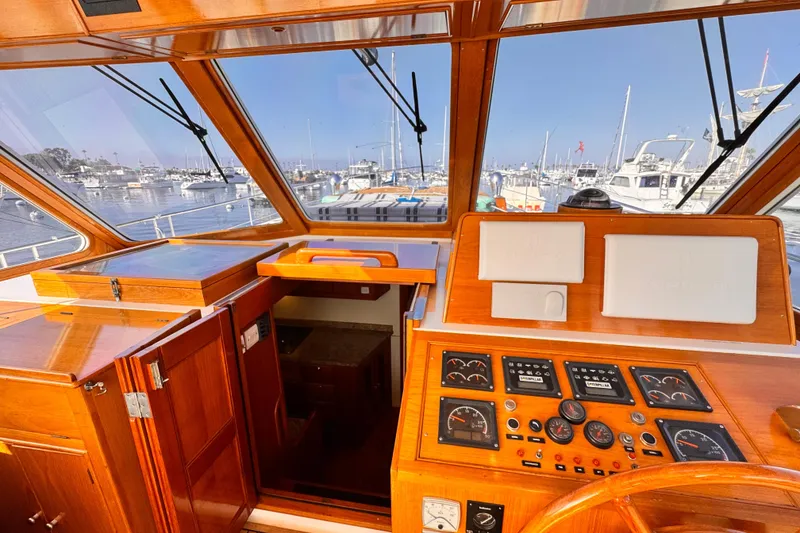 Slide: The Image of Helm of 2000 Grand Banks East Bay 49 yacht with marina view. - 6