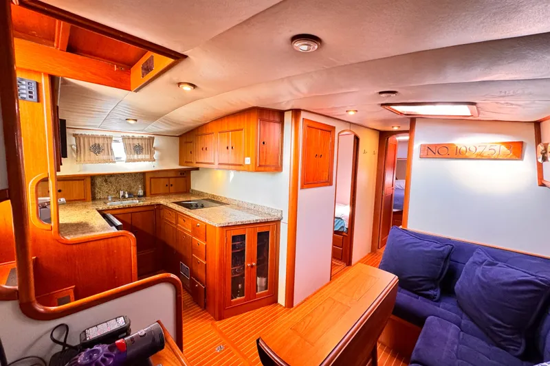 Slide: The Image of Luxurious 2000 Grand Banks East Bay 49 yacht interior with wood cabinetry and cozy seating. - 9