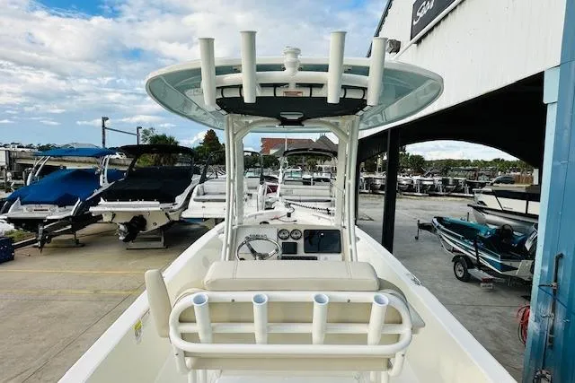 Slide: The Image of 2025 Boston Whaler 250 Dauntless boat at marina, showcasing helm and seating area. - 10