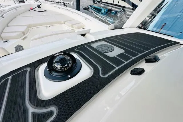 Slide: The Image of 2025 Boston Whaler 250 Dauntless boat deck with compass and seating area. - 17