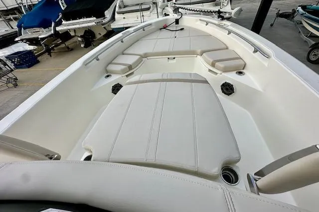Slide: The Image of 2025 Boston Whaler 250 Dauntless boat interior with cushioned seating and storage compartments. - 19