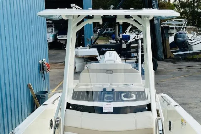 Slide: The Image of 2025 Boston Whaler 250 Dauntless boat docked at marina, rear view. - 22