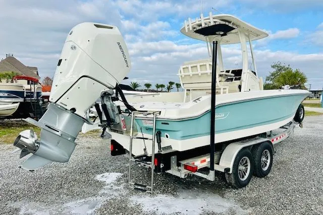 Slide: The Image of 2025 Boston Whaler 250 Dauntless boat on trailer, featuring a powerful outboard motor. - 3