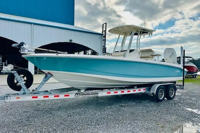 Slide: The Image of 2025 Boston Whaler 250 Dauntless boat on trailer, parked outdoors under cloudy sky. - 5
