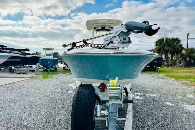 Slide: The Image of 2025 Boston Whaler 250 Dauntless boat on trailer, parked outdoors under cloudy sky. - 6