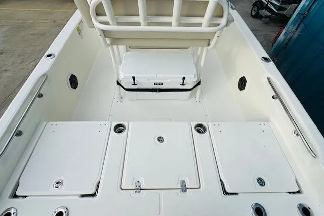 Slide: The Image of 2025 Boston Whaler 250 Dauntless boat interior with storage compartments and cooler. - 8