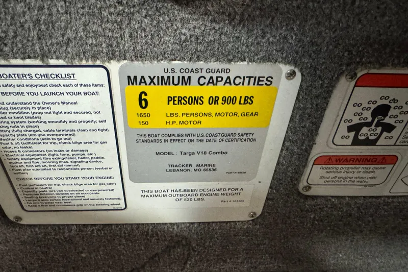 Slide: The Image of 2014 Tracker Targa V-18 Combo capacity label, 6 persons or 900 lbs, safety warnings. - 12