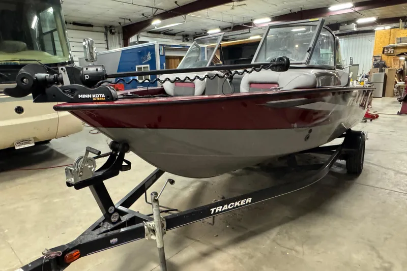 Slide: The Image of 2014 Tracker Targa V-18 Combo boat on trailer in garage setting. - 2