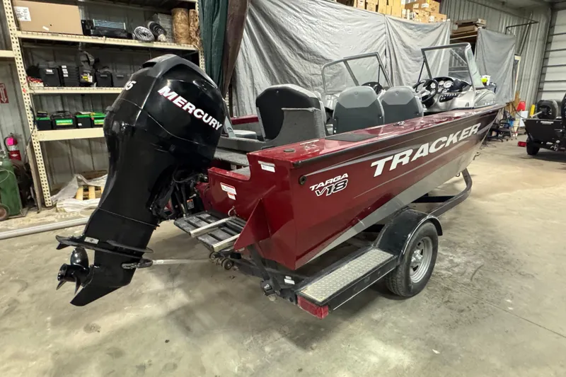 Slide: The Image of 2014 Tracker Targa V-18 Combo boat with Mercury engine in a garage setting. - 3