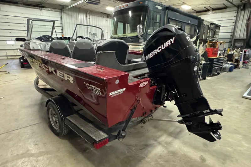 Slide: The Image of 2014 Tracker Targa V-18 Combo boat with Mercury outboard motor in a garage. - 4