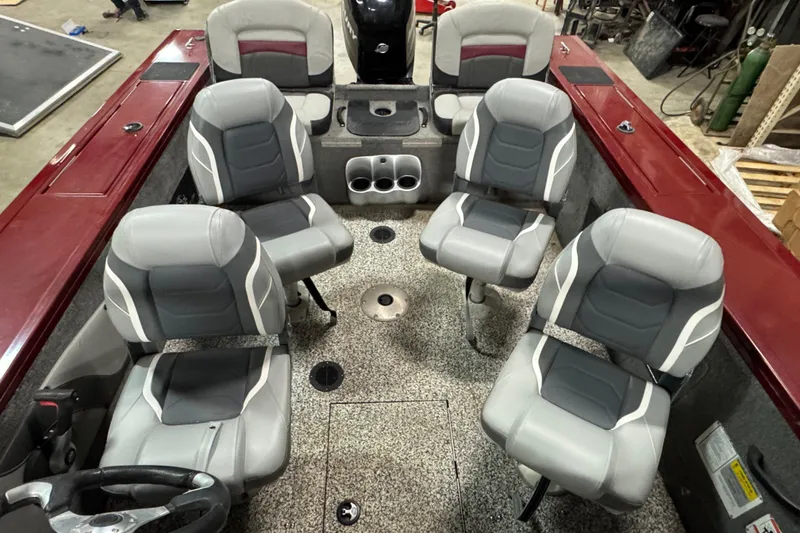 Slide: The Image of 2014 Tracker Targa V-18 Combo boat interior with six gray seats and red accents. - 6