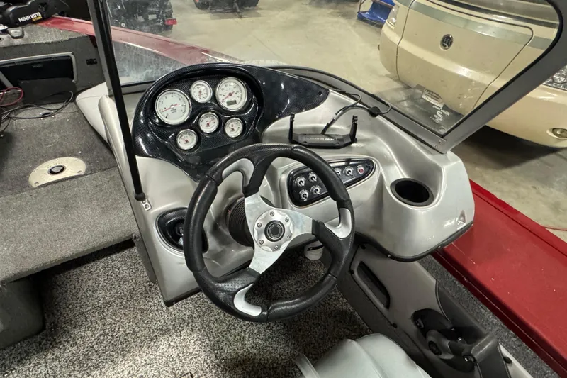 Slide: The Image of 2014 Tracker Targa V-18 Combo boat dashboard with steering wheel and gauges. - 8