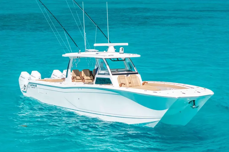 The Image of Manufacturer Provided Image: 2025 Caymas 44 CT boat cruising on clear turquoise water. - 0
