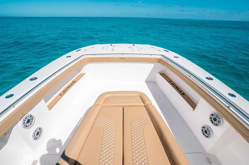 Slide: The Image of Manufacturer Provided Image: 2025 Caymas 44 CT boat interior with tan seating, on clear blue ocean. - 3