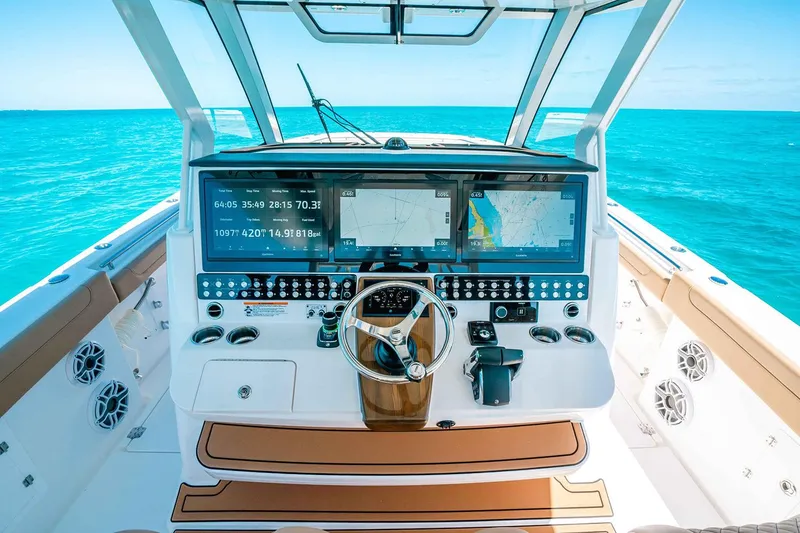 Slide: The Image of Manufacturer Provided Image: Helm of 2025 Caymas 44 CT boat with advanced navigation screens and controls. - 6
