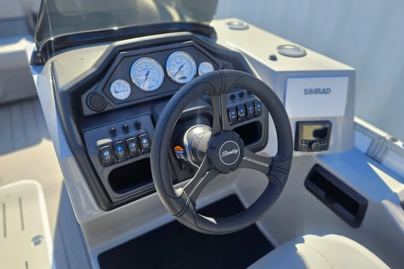 Slide: The Image of Steering console of 2026 Bentley Pontoons Legacy 223 Swingback with gauges and controls. - 13
