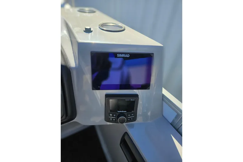 Slide: The Image of 2026 Bentley Pontoons Legacy 223 Swingback dashboard with Simrad display and controls. - 14