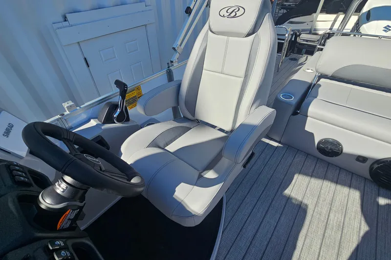 Slide: The Image of 2026 Bentley Pontoons Legacy 223 Swingback interior with steering wheel and seating. - 15