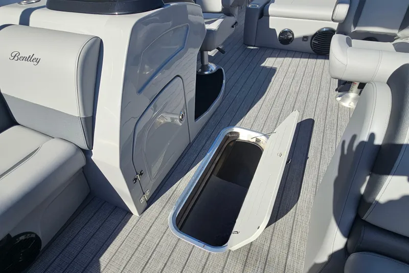 Slide: The Image of 2026 Bentley Pontoons Legacy 223 Swingback interior with open storage compartment. - 16
