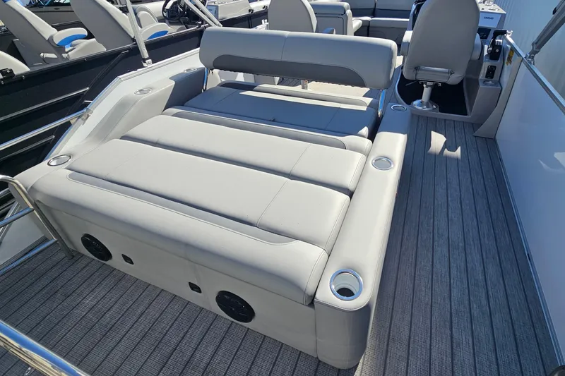 Slide: The Image of 2026 Bentley Pontoons Legacy 223 Swingback interior with luxurious seating and cup holders. - 20