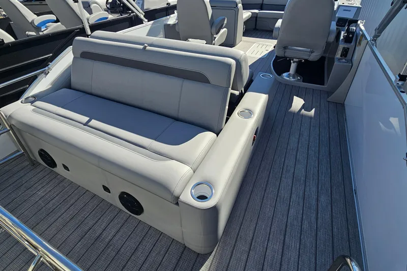 Slide: The Image of 2026 Bentley Pontoons Legacy 223 Swingback interior with gray seating and cup holders. - 21