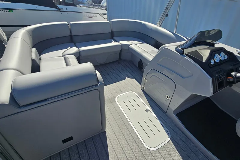 Slide: The Image of 2026 Bentley Pontoons Legacy 223 Swingback interior with luxurious seating and modern dashboard. - 9