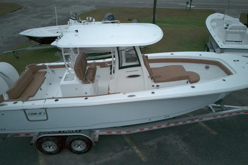 The Image of 2026 Sea Hunt Ultra 285 Coffin Box boat on trailer, featuring spacious seating and sleek design. - 0