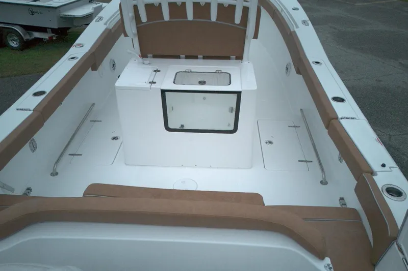 Slide: The Image of 2026 Sea Hunt Ultra 285 Coffin Box boat interior with cushioned seating and storage. - 6