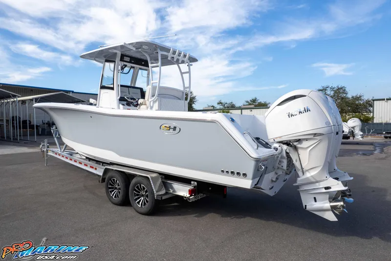 Slide: The Image of 2026 Sea Hunt Gamefish 30 Coffin Box boat on trailer, featuring Yamaha outboard engines. - 10