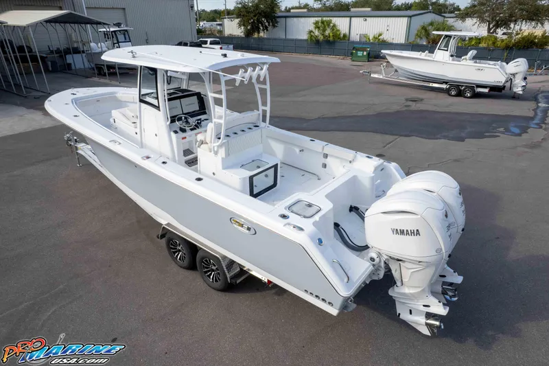 Slide: The Image of 2026 Sea Hunt Gamefish 30 Coffin Box boat with Yamaha engines, parked on a trailer. - 11