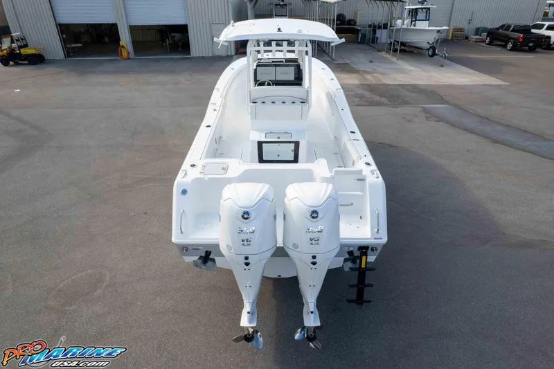 Slide: The Image of 2026 Sea Hunt Gamefish 30 Coffin Box boat with dual outboard engines, docked at a marina. - 12