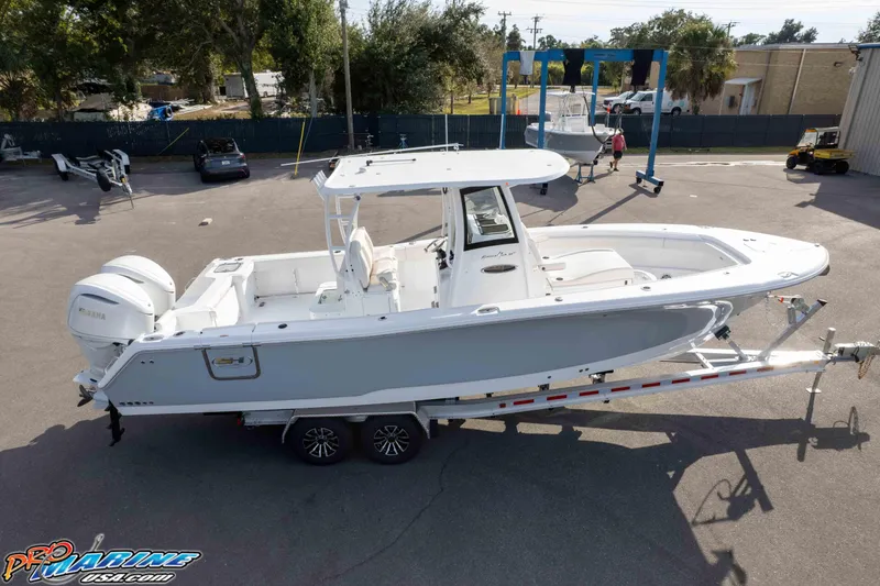 Slide: The Image of 2026 Sea Hunt Gamefish 30 Coffin Box boat on trailer in marina setting. - 14