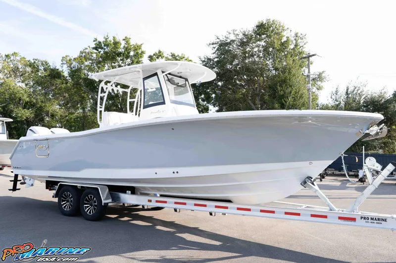 Slide: The Image of 2026 Sea Hunt Gamefish 30 Coffin Box boat on trailer, side view, outdoors. - 18