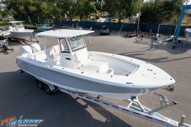 Slide: The Image of 2026 Sea Hunt Gamefish 30 Coffin Box boat on trailer in outdoor lot. - 2