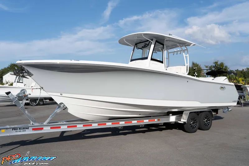 Slide: The Image of 2026 Sea Hunt Gamefish 30 Coffin Box boat on trailer, clear sky background. - 21