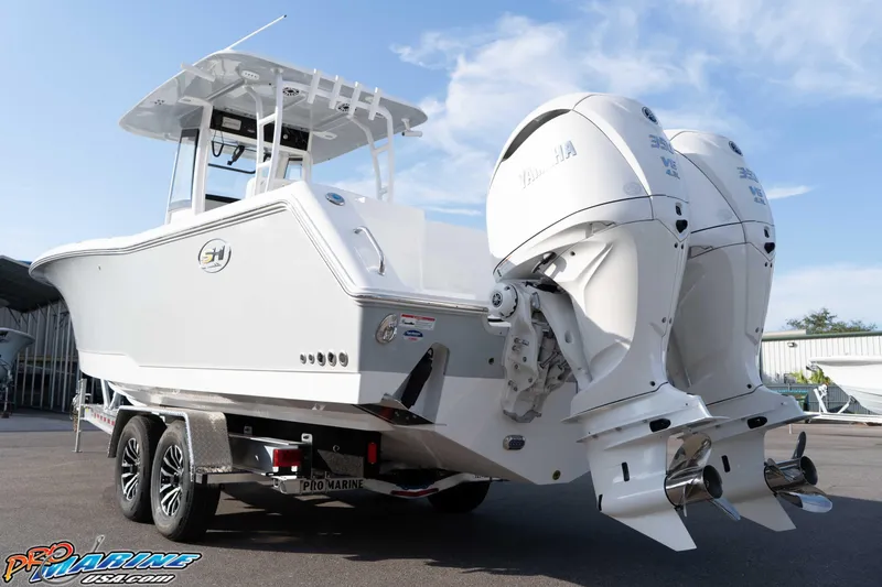 Slide: The Image of 2026 Sea Hunt Gamefish 30 Coffin Box boat with dual Yamaha engines on trailer. - 23