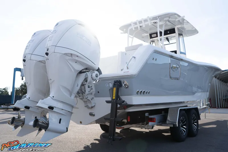Slide: The Image of 2026 Sea Hunt Gamefish 30 Coffin Box boat with dual outboard engines on a trailer. - 26